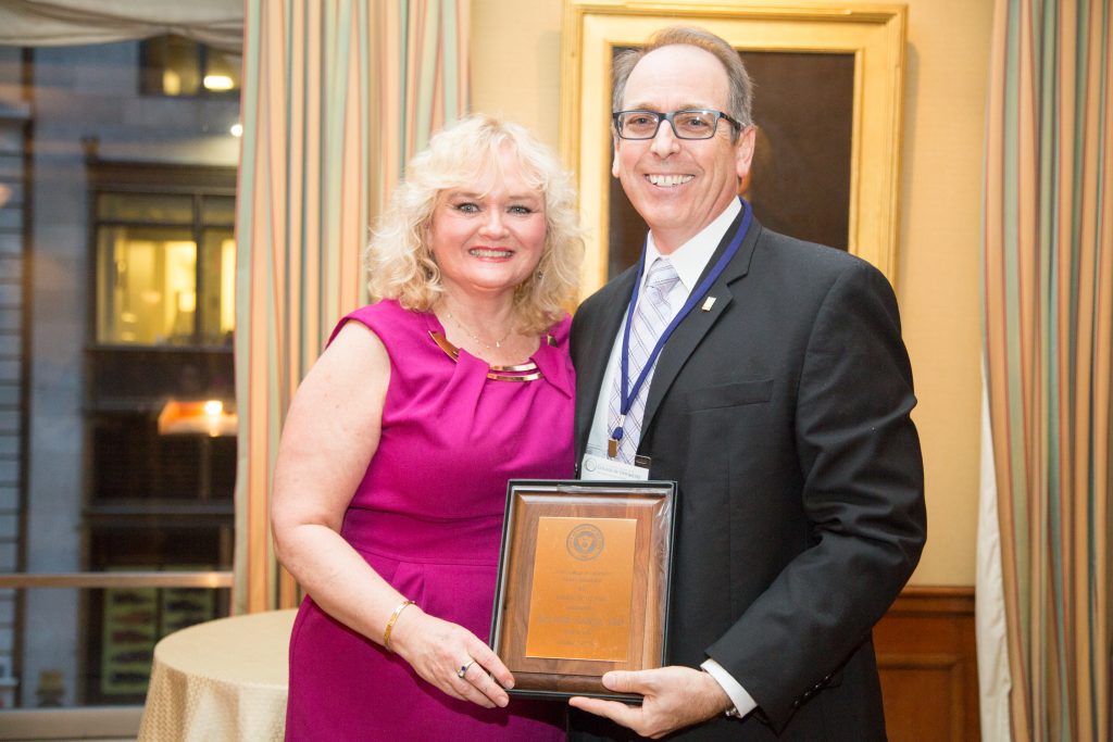 Dr. Denise Whittam, president of the College's alumni association, congratulates 2017 Alumnus of the Year Dr. Ken Sorkin.