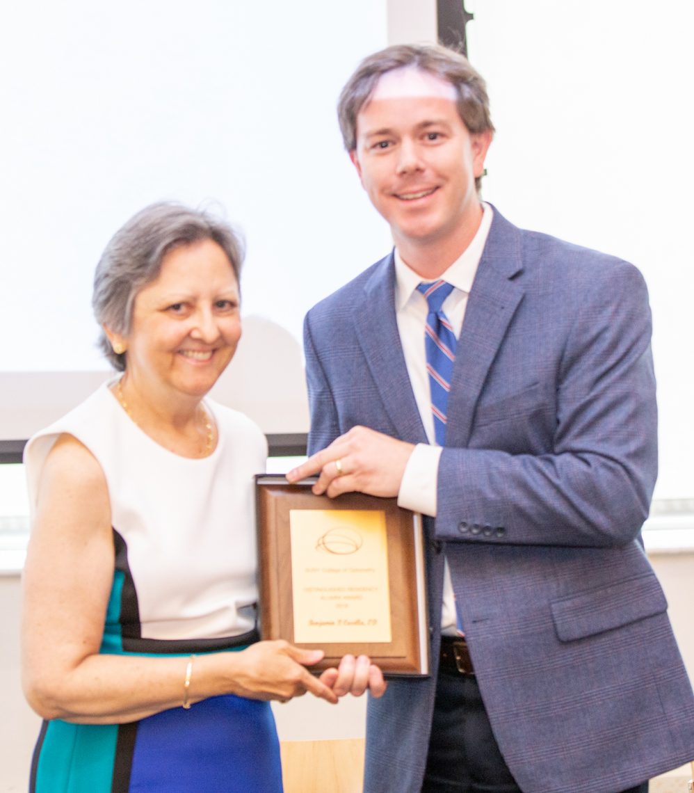 SUNY Optometry director of residency programs Dr. Diane Adamczyk presents Dr. Benjamin Casella with the 2019 Distinguished Residency Alumni Award during the annual Resident's Farewell Reception, June 14, 2019