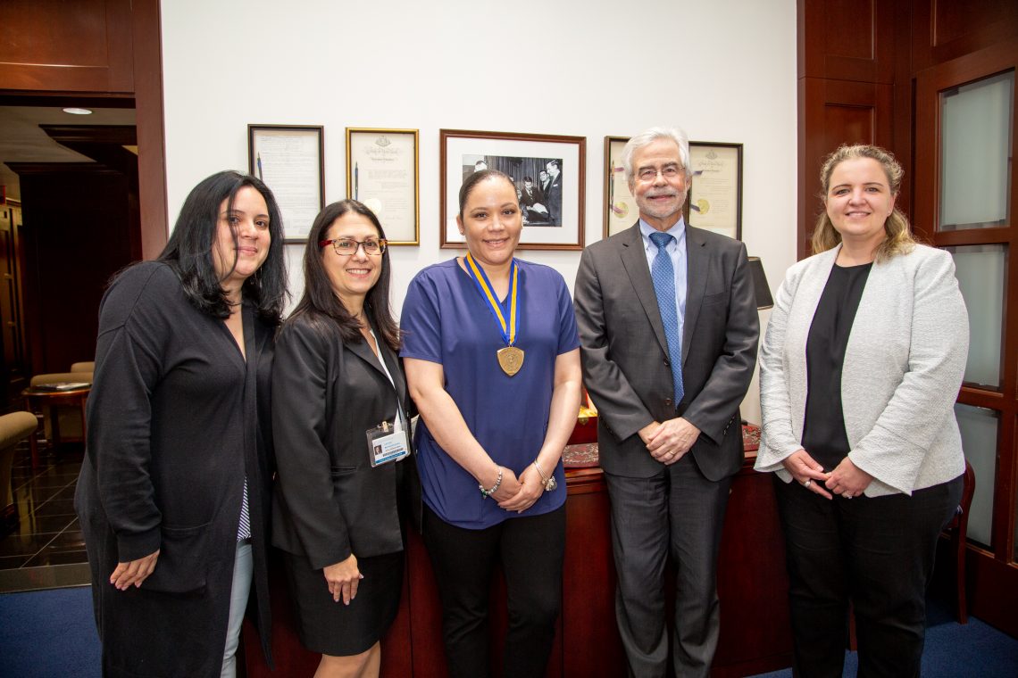 Chancellor's Award for Excellence in Classified Service recipient Kali Berrios (center) with (l-r) Sheryl Carattini, clinic manager for contact lens and pediatric services; Liduvina Martinez-Gonzalez, executive director of the University Eye Center; Dr. David A. Heath, SUNY Optometry president; Dr. Eva Duchnowski, associate clinical professor and contact lens section chief, June 5, 2019.